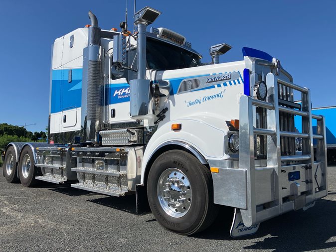 View a white 2013 Kenworth T909 available via auction.