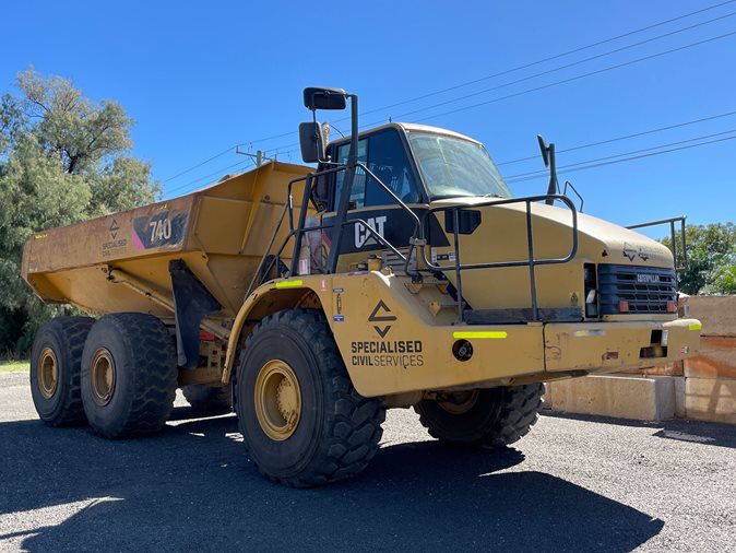 View a yellow 2010 Caterpillar 740 available via auction.