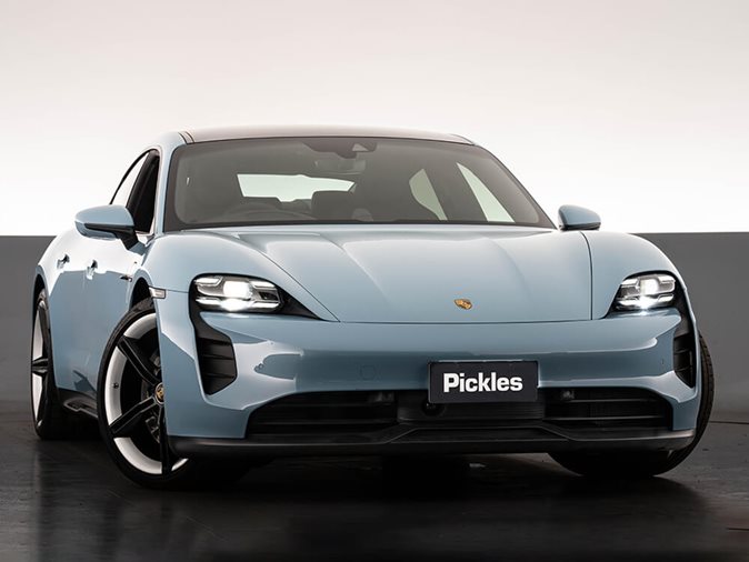 View a blue fully electric 2023 Porsche Taycan available via auction.